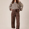 Moxie Barrel Eyelet Jeans in Polka Dot Brown front view with relaxed barrel leg fit and white dot print