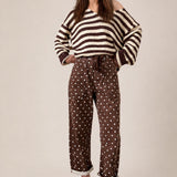 Moxie Barrel Eyelet Jeans in Polka Dot Brown front view with relaxed barrel leg fit and white dot print