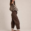 Side view of Moxie brown polka dot barrel jeans
