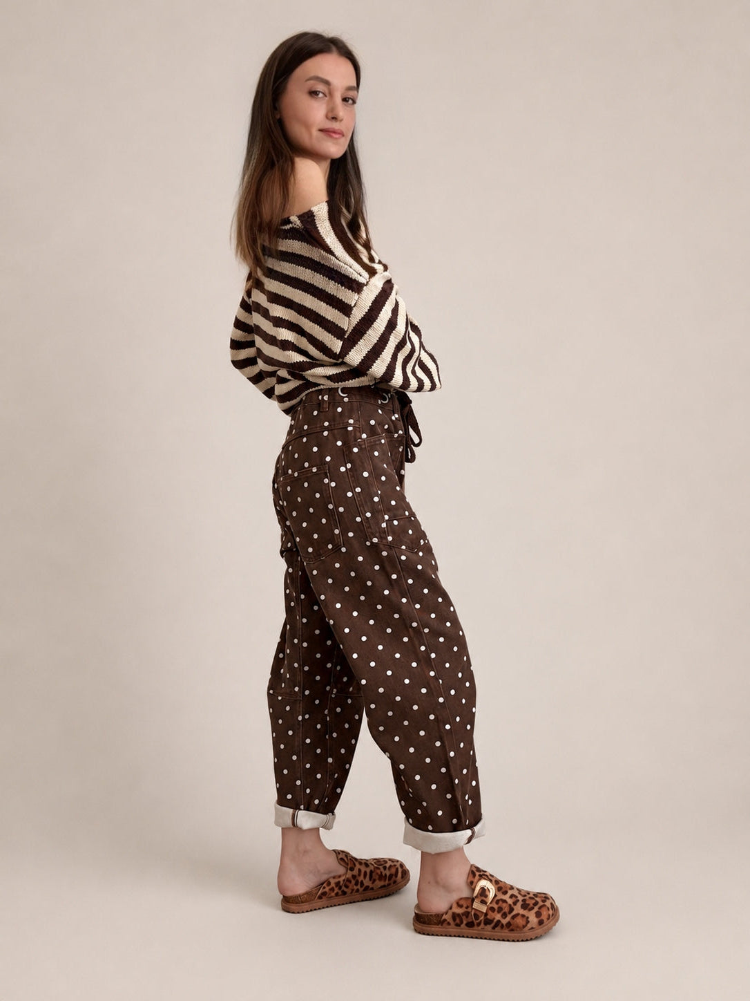Side view of Moxie brown polka dot barrel jeans