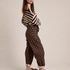 Side view of Moxie brown polka dot barrel jeans