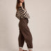 Side view of Moxie brown polka dot barrel jeans