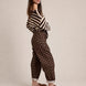 Side view of Moxie brown polka dot barrel jeans