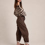 Side view of Moxie brown polka dot barrel jeans
