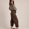Side view of Moxie brown polka dot barrel jeans