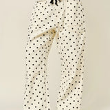 Front view of Moxie Barrel Eyelet Jeans in polka dot cream with eyelet waist detail