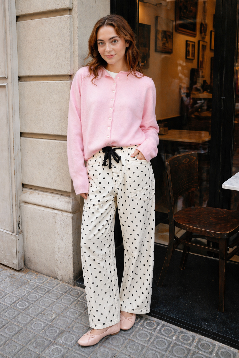Woman wearing Moxie Barrel Eyelet Jeans in polka dot cream with a pink cardigan