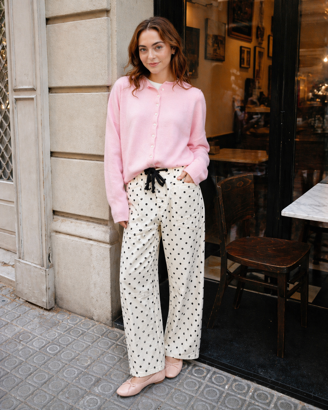 Woman wearing Moxie Barrel Eyelet Jeans in polka dot cream with a pink cardigan