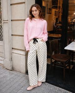 Woman wearing Moxie Barrel Eyelet Jeans in polka dot cream with a pink cardigan