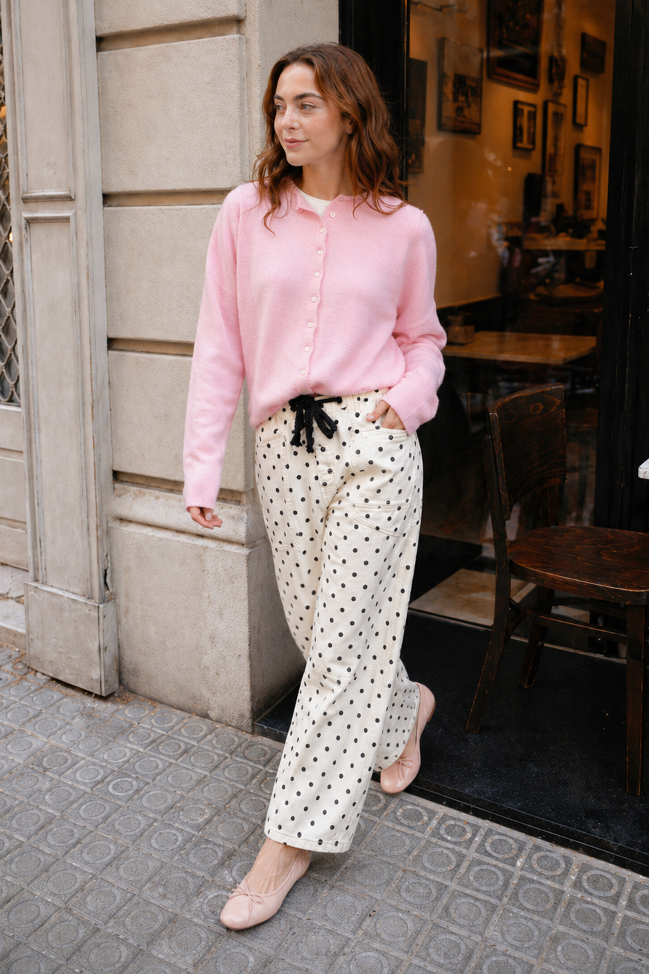Woman wearing Moxie Barrel Eyelet Jeans in polka dot cream with a pink cardigan
