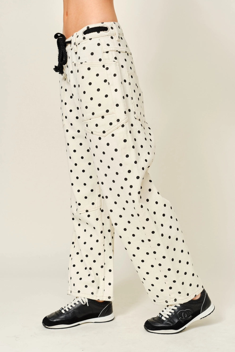 Side view of Moxie Barrel Eyelet Jeans in polka dot cream with tapered barrel leg