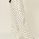 Side view of Moxie Barrel Eyelet Jeans in polka dot cream with tapered barrel leg