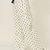Side view of Moxie Barrel Eyelet Jeans in polka dot cream with tapered barrel leg