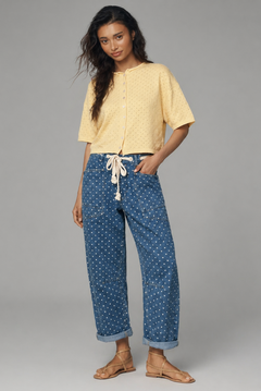 Woman wearing Moxie Polka Dot Barrel Jeans in Denim and yellow top styled in a full outfit on a gray background