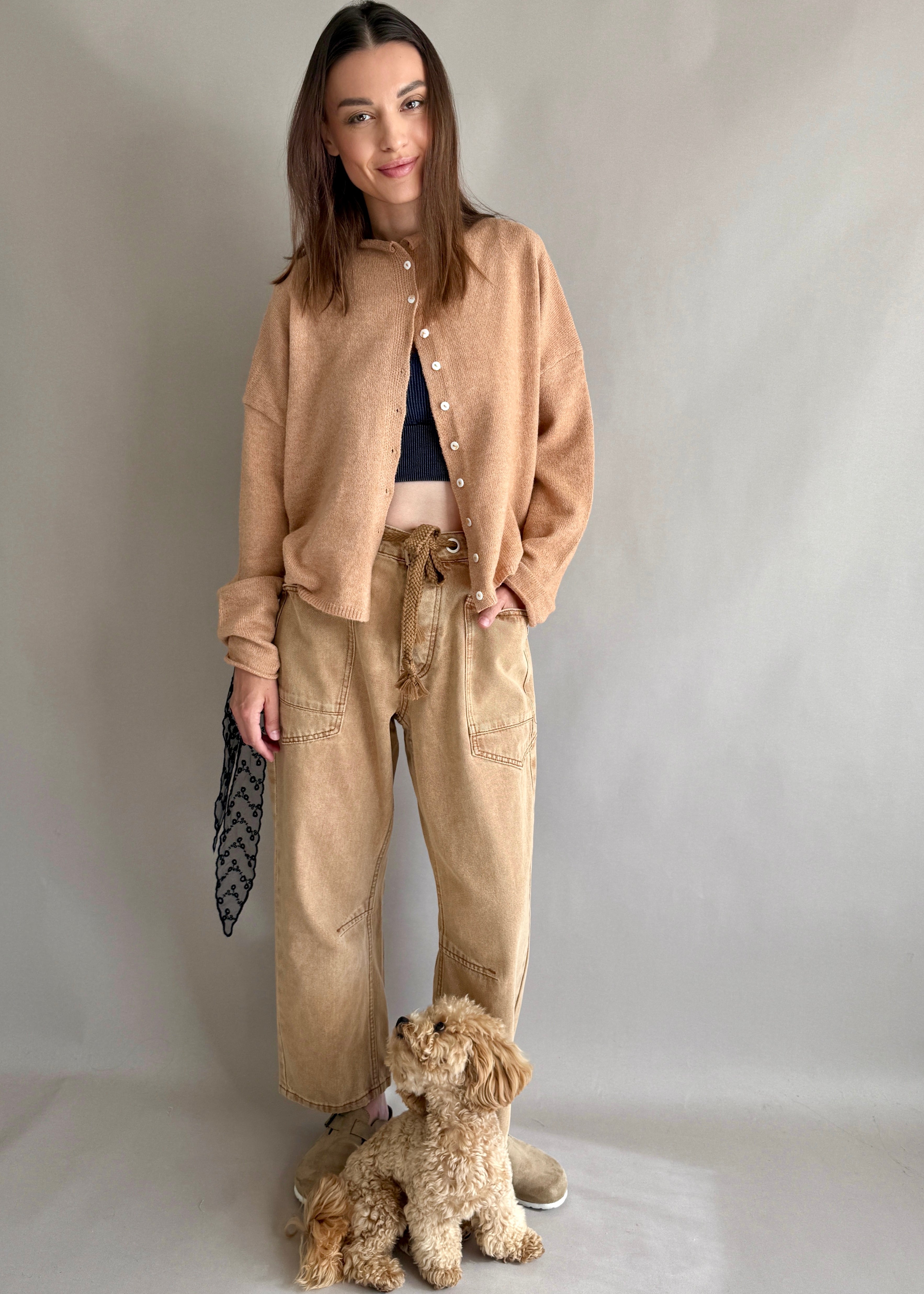 Front lifestyle view of model wearing the Moxie Barrel Eyelet Jeans in rust