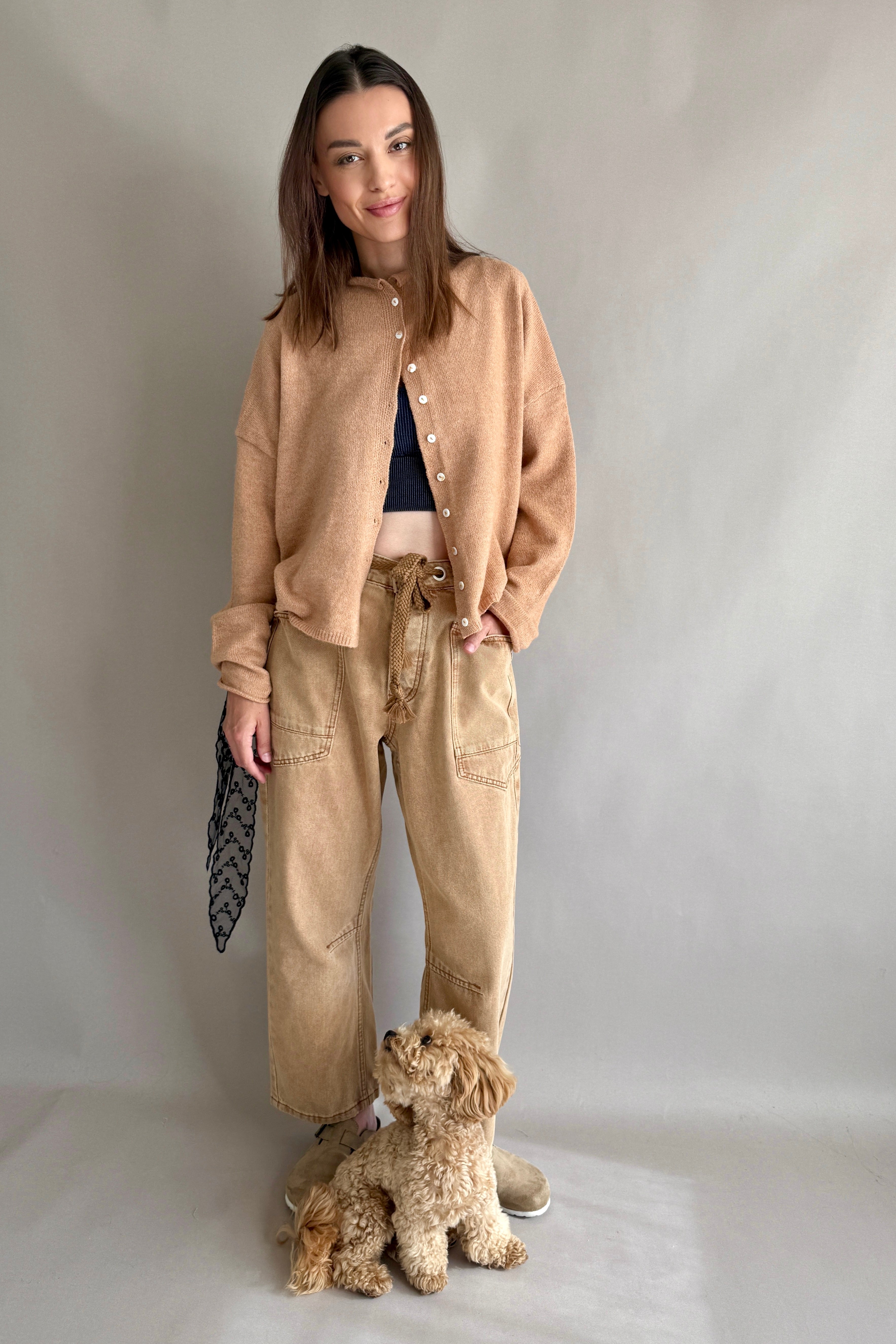 Front lifestyle view of model wearing the Moxie Barrel Eyelet Jeans in rust