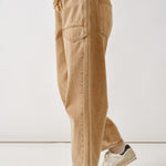 Side view of the rust barrel eyelet jeans highlighting cropped length