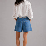 Model wearing Moxie Barrel Shorts in Denim Dot styled with an easy everyday top for a relaxed casual outfit. - back view