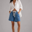 Model wearing Moxie Barrel Shorts in Denim Dot styled with an easy everyday top for a relaxed casual outfit.