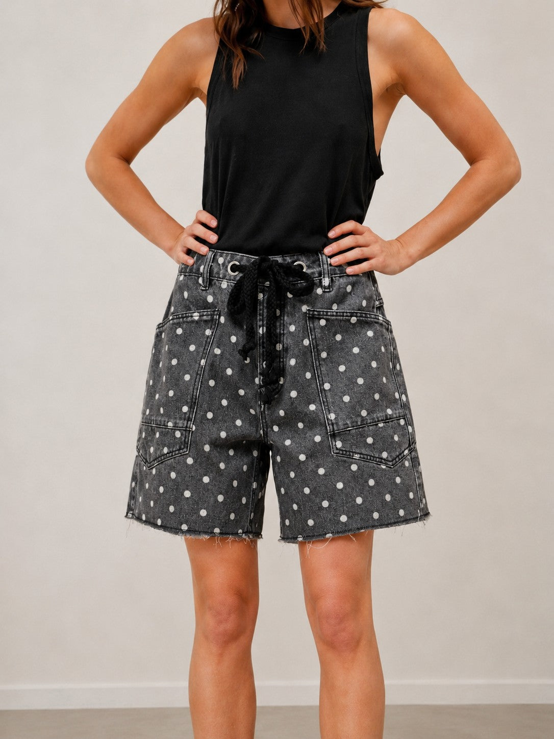 Front view of Moxie Barrel Shorts in charcoal black with white polka dots