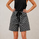 Front view of Moxie Barrel Shorts in charcoal black with white polka dots