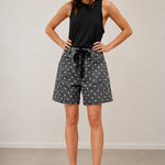 Moxie Barrel Shorts in charcoal black with white polka dots styled with a black tee
