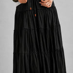 Adjustable drawstring waist on the One Brynn black cotton tiered maxi skirt