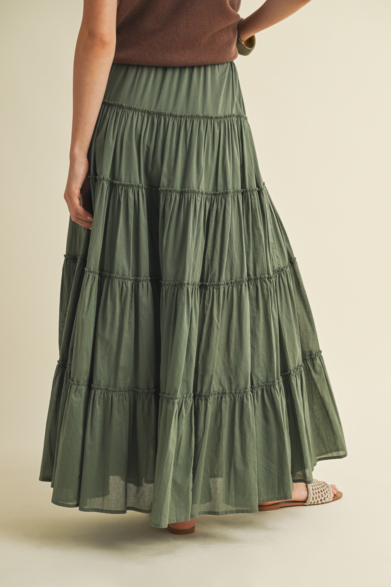 Back view of the cotton tiered maxi skirt in dill green