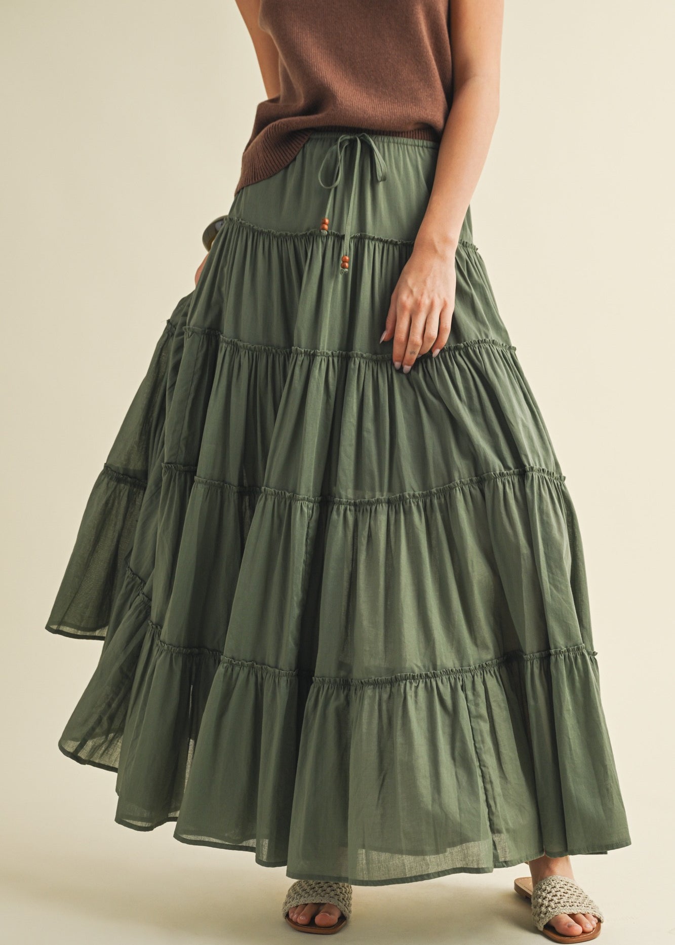 Front portrait of model wearing the One Brynn Cotton Tiered Maxi Skirt in dill green