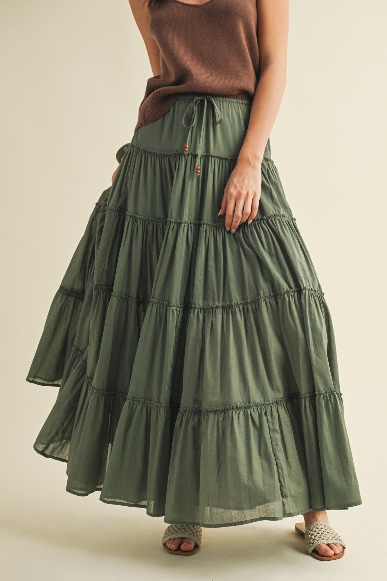 Front portrait of model wearing the One Brynn Cotton Tiered Maxi Skirt in dill green