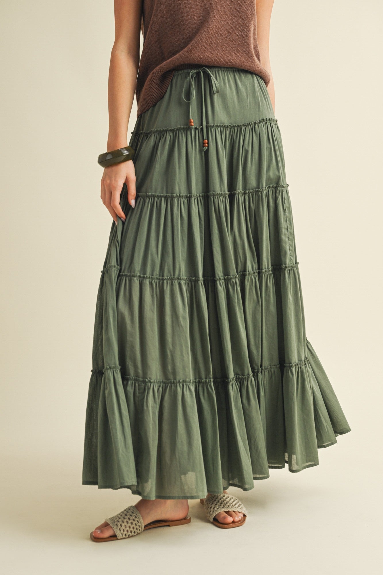 Front view of the One Brynn Cotton Tiered Maxi Skirt in dill (green) showing tiered silhouette