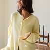 Woman wearing the Hailey Button Down Cardigan, also known as the Piper Cardigan — soft yellow lightweight knit with button front and rolled edges.