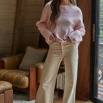 Model wearing the Piper Soft Knit Crew Sweater in Baby Pink with relaxed neutral pants - full view