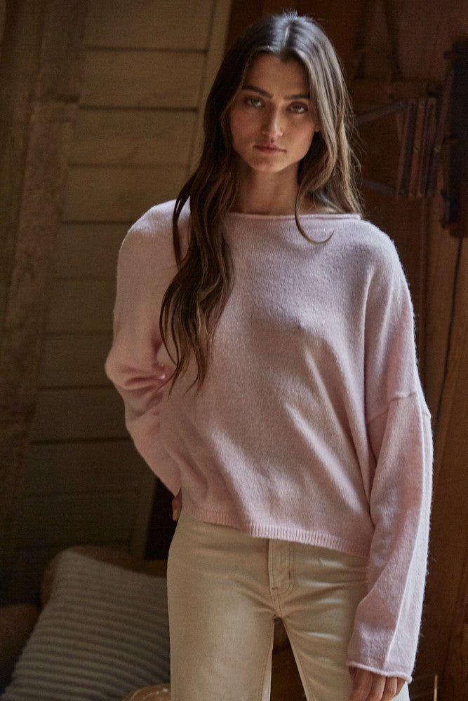 Model wearing the Piper Soft Knit Crew Sweater in Baby Pink with relaxed neutral pants