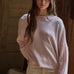 Model wearing the Piper Soft Knit Crew Sweater in Baby Pink with relaxed neutral pants