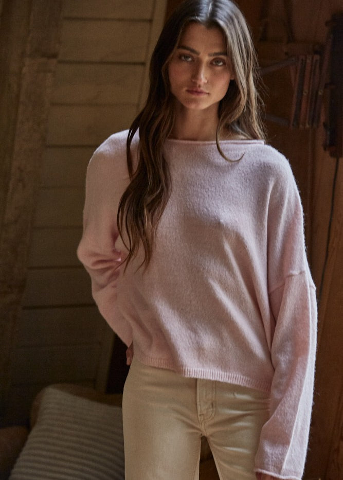 Model wearing the Piper Soft Knit Crew Sweater in Baby Pink with relaxed neutral pants