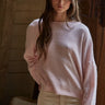 Model wearing the Piper Soft Knit Crew Sweater in Baby Pink with relaxed neutral pants