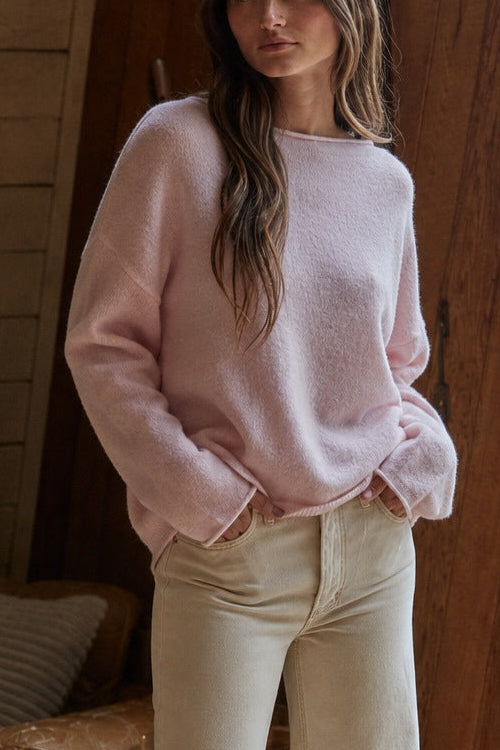 Model wearing the Piper Soft Knit Crew Sweater in Baby Pink with relaxed neutral pants - full view - side front fiew