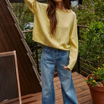 Model wearing the Piper Soft Knit Crew Sweater in Banana with relaxed neutral pants - full outfit