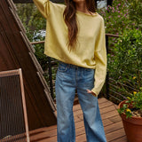 Model wearing the Piper Soft Knit Crew Sweater in Banana with relaxed neutral pants - full outfit