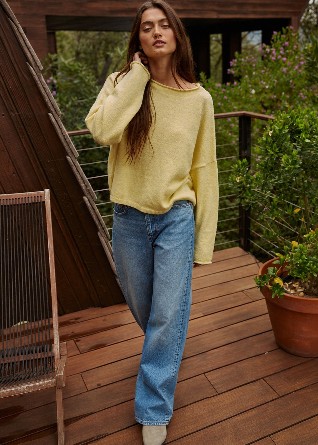 Model wearing the Piper Soft Knit Crew Sweater in Banana with relaxed neutral pants - walking
