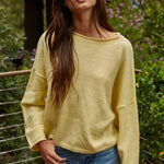 Model wearing the Piper Soft Knit Crew Sweater in Banana with relaxed neutral pants