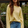 Model wearing the Piper Soft Knit Crew Sweater in Banana with relaxed neutral pants - front view