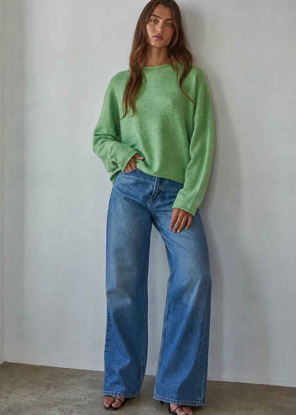 Model wearing the Piper Soft Knit Crew Sweater in Green with relaxed neutral pants - full outfit