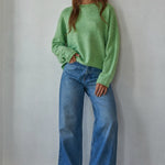 Model wearing the Piper Soft Knit Crew Sweater in Green with relaxed neutral pants - full outfit