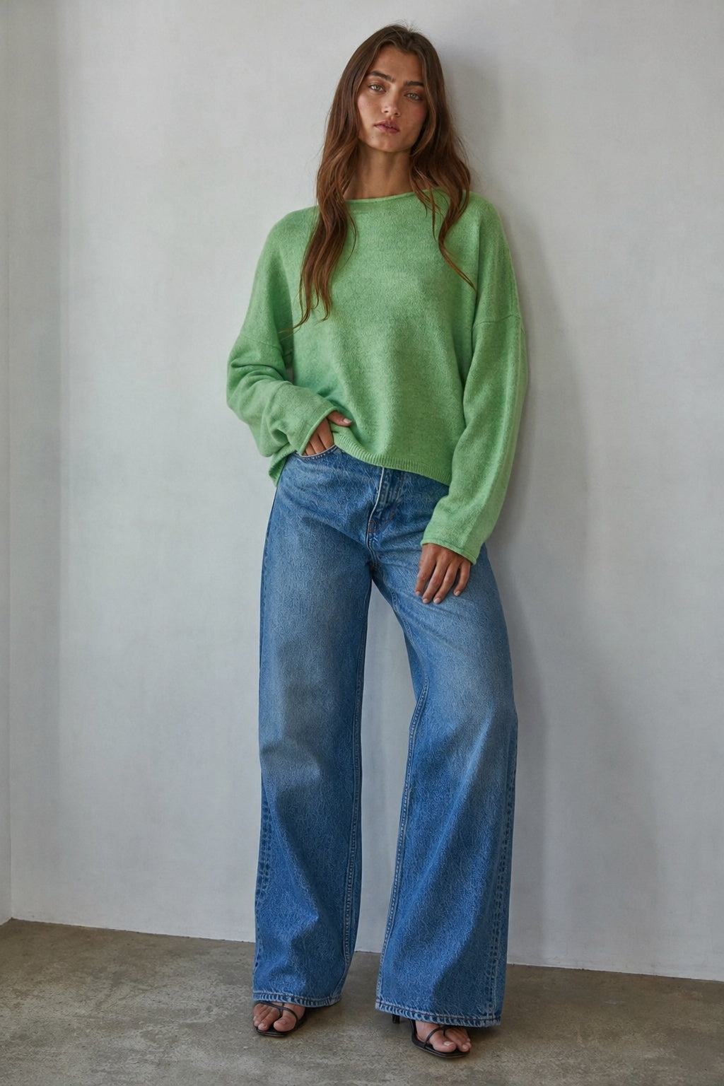 Model wearing the Piper Soft Knit Crew Sweater in Green with relaxed neutral pants - full outfit