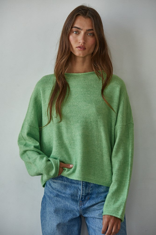 Model wearing the Piper Soft Knit Crew Sweater in Green with relaxed neutral pants - front view- main image