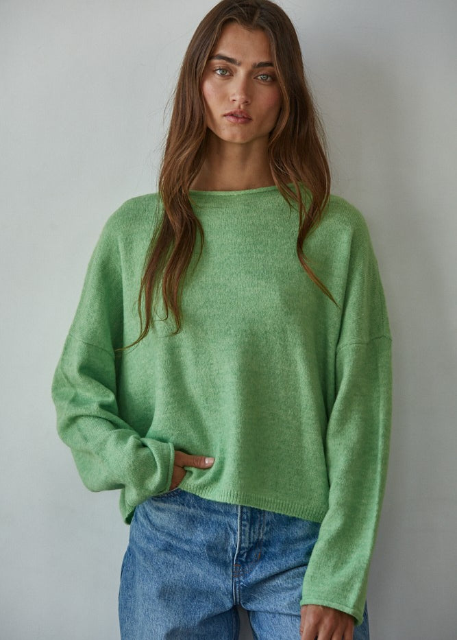 Model wearing the Piper Soft Knit Crew Sweater in Green with relaxed neutral pants - front view- main image