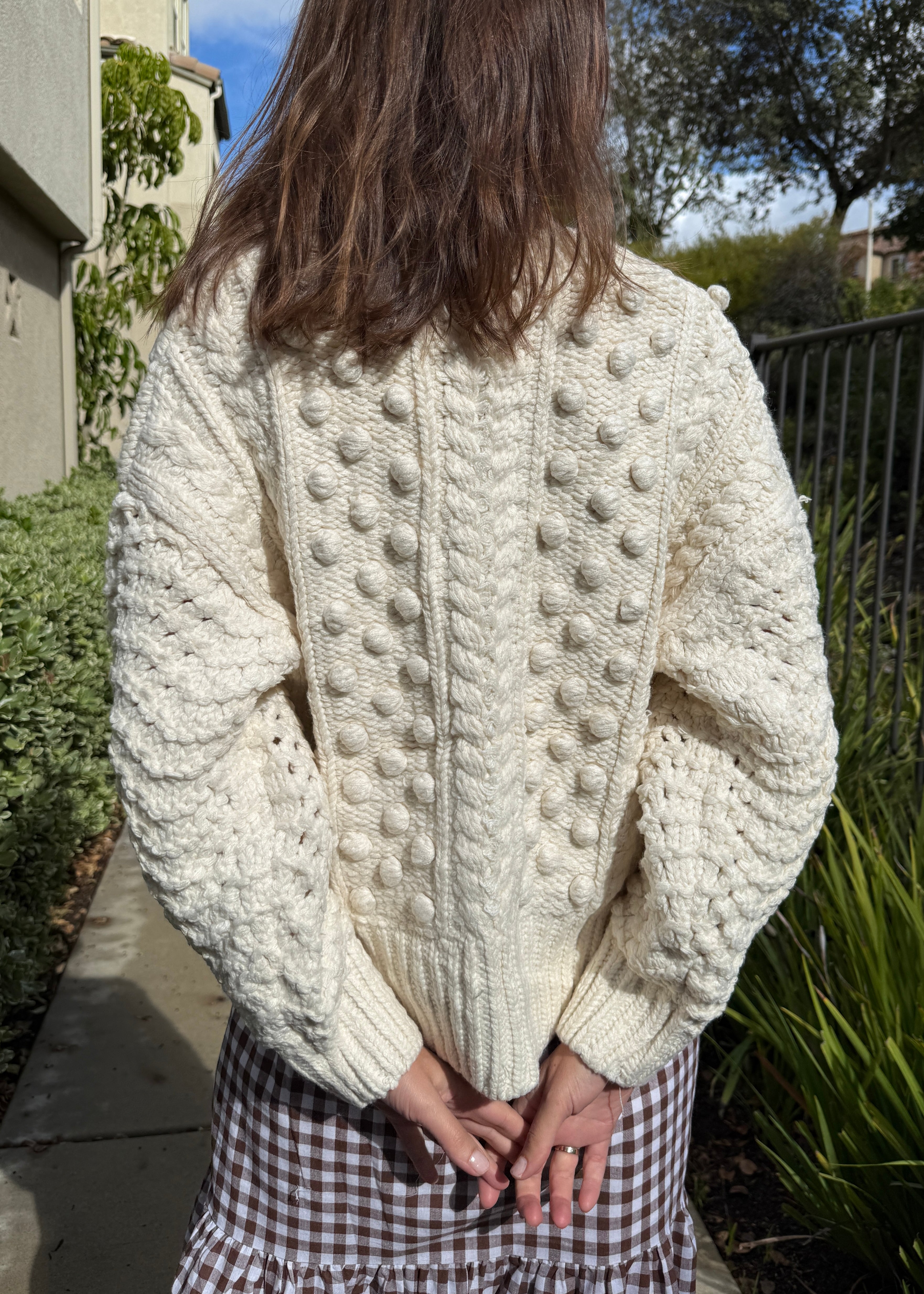 Back view of the Popcorn Stitch Chunky Knit Cardigan in ivory showing textured knit