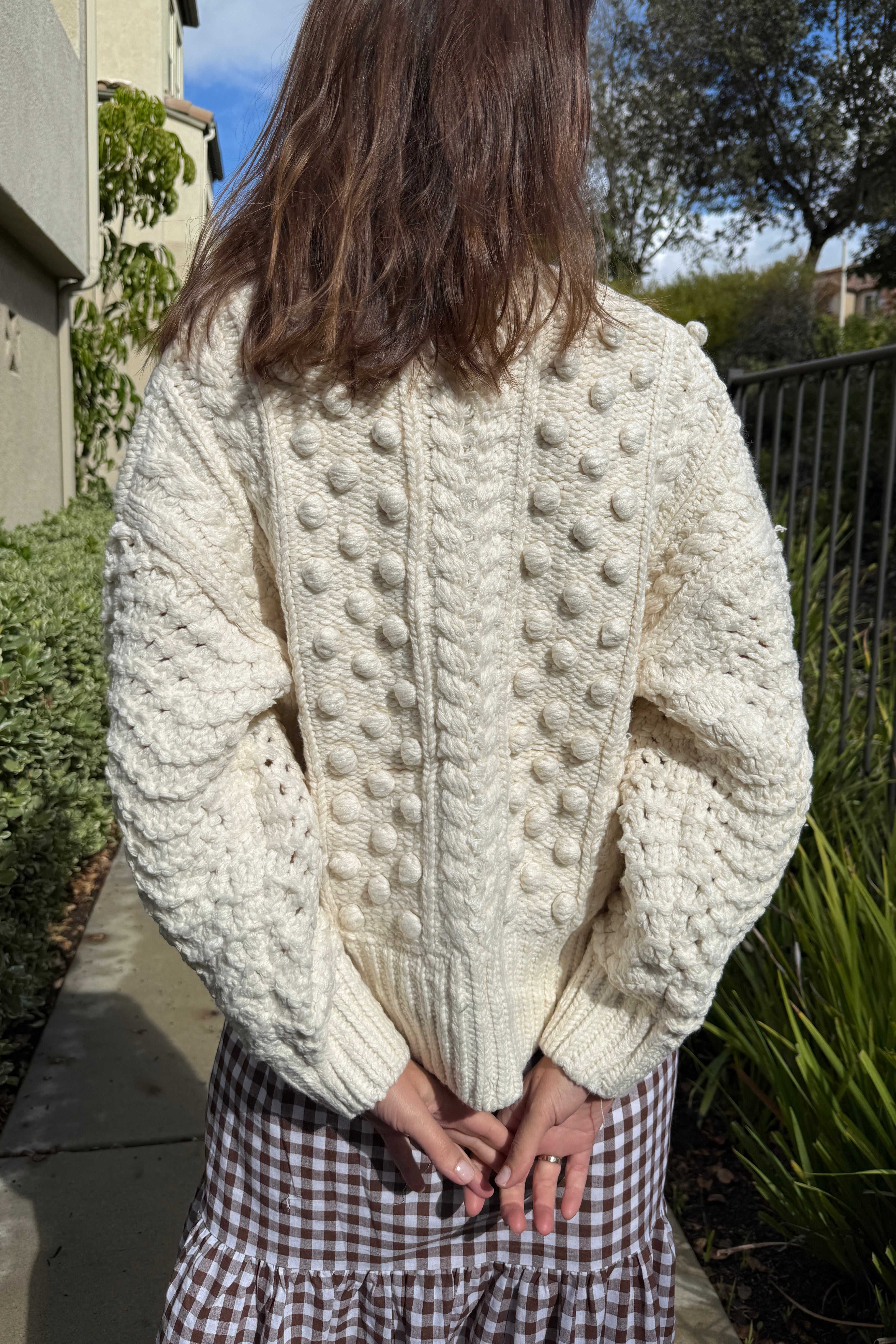 Back view of the Popcorn Stitch Chunky Knit Cardigan in ivory showing textured knit